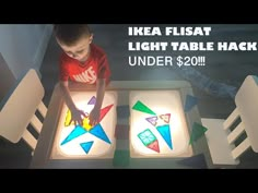 a young boy standing in front of a light table with paper stars on it and the words ikea flash light table hackr under $ 20