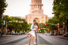 a man and woman are hugging on the street