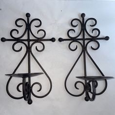 two wrought iron wall shelves on white background