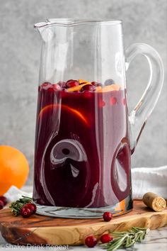 a pitcher filled with sangria sitting on top of a cutting board