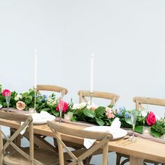 the table is set with flowers and candles