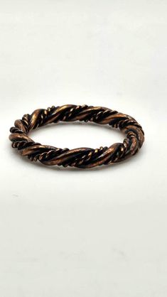 Interesting and understated vintage copper ring. This ring has a twisted design with one strand solid intertwined with a braided strand creating a  unique look and texture than the everyday solid band. Excellent vintage condition. Expedited shipping is available by request on a case by case basis. Please message us if you require rush shipping. Returns are are accepted within the time window noted. To recieve a full refund the return must meet one of the following criteria. All other returns are Braided Copper Rings, Braided Ring Band, Twisted Braid, Braided Ring, Chandler Az, Copper Ring, Copper Rings, Twist Braids, Vintage Copper