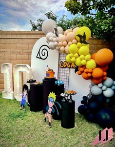 an outdoor party with balloons and decorations