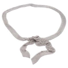 Tiffany & Co. Mesh Tie Scarf / Necklace from the Elsa Peretti Collection finely crafted in sterling silver with a woven mesh chain link design throughout , measuring 49" long and weighs 141.4 grams total, the scarf measures 1" wide approximately. Fully hallmarked. This neckpiece can be worn as a scarf, tie or belt. This is a discontinued model. Necklace Specifications Brand: Tiffany & Co. Style: Elsa Peretti Hallmarks: © Tiffany & Co. STERLING PERETTI Metal: Sterling Silver Length: 49" Width: 1" Luxury Silver Chain Necklace For Party, Luxury Silver Chain Necklace For Formal Occasions, Elegant White Gold Chain Necklace For Party, Elegant Evening Lariat Chain Necklace, Elegant Lariat Chain Necklace For Evening, Luxury Silver Chain Necklace For Evening, Luxury Silver Chain Necklace For Wedding, Elegant Silver Lariat Chain Necklace, Luxury Lariat Chain Necklace For Evening