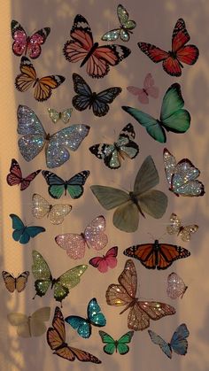 a group of butterflies that are flying in the air with glitters on their wings