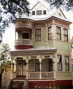 an old victorian house in the middle of town