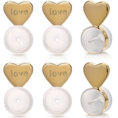 four pairs of gold and white heart shaped studs with love written on the backs