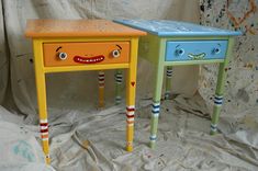 two colorful tables with faces painted on them