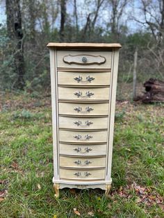 an old dresser is sitting in the grass