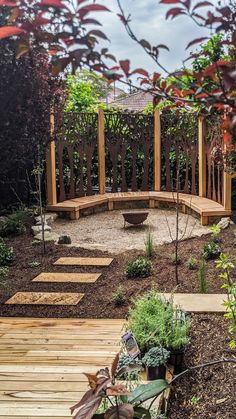 a wooden bench sitting in the middle of a garden