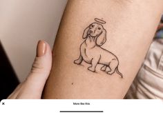 a small dog tattoo on the arm