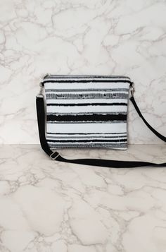 "Going somewhere warm? Our black and white crossbody bag is the perfect addition to any outfit.  Credit card holder, key loop with a matching key lanyard. One pocket. 10.5\" x 9.5\"" White Crossbody Shoulder Bag With Zipper Pouch, Black And White Rectangular Bags For Everyday Use, Black And White Rectangular Bag For Everyday Use, Rectangular Black And White Bag For Everyday Use, Black And White Rectangular Everyday Bag, Rectangular Black And White Travel Bag, Utica Ny, Black And White Bags, White Crossbody Bag