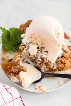 an ice cream sundae on a plate with a spoon