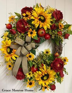 a wreath with sunflowers and apples on it