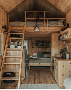 there is a loft bed and stairs in this small cabin with wood walls, wooden flooring, and built - in shelving