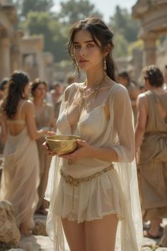 a woman in a white dress holding a bowl