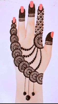 hendi design on the palm of a woman's hand with beads and rings