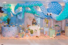 an under the sea themed birthday party with balloons, decorations and other items on display