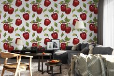 a living room filled with furniture and wallpaper covered in red apples on the wall