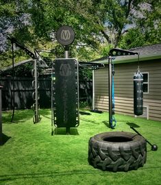 a backyard with grass and an exercise equipment set up