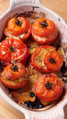 tomatoes in a white dish on a wooden table