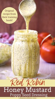 red robin honey mustard poppy seed dressing in a mason jar with a spoon pouring it into the jar