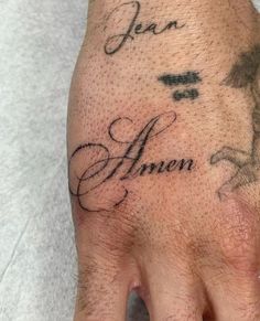 a person's hand with a tattoo that says jean and anon on it