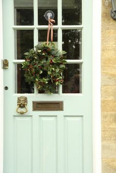 a blue front door with a wreath on it