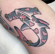 a shark with hearts on it's tail and the word love is in the shape of an anchor