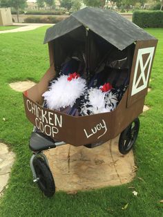 the chicken coop is made out of cardboard and has feathers on it's wheels