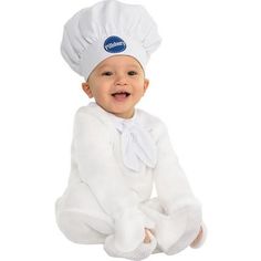 a baby wearing a chef's hat and sitting on the floor