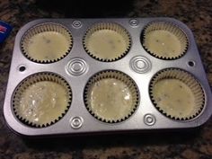 a muffin tin filled with cupcakes sitting on top of a counter