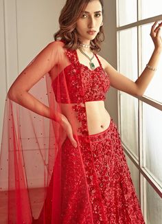 This gorgeous outfit is perfect for your wedding day! Features a ravishing red lehenga and bralette blouse with red sequins hand embroidered throughout the attire which looks glamorous and royal at the same time. The outfit is paired with red four sides sequins embroidered net dupatta. Composition : Blouse and Lehenga -Organza, Dupatta - Soft Net Care: Dry Clean Only and Vacuum Storage This product can be customised for sleeves, length of blouse and neckline Delivery : 6-8 weeks as the product is hand crafted. Check Size Guide or choose MySize for free customisation (All Sizes above XL can be made at 15% additional cost) For more information and sizes please contact fabiliciousfashion@gmail.com or visit our Copenhagen studio. Red Pre-draped Saree With Intricate Embroidery For Party, Glamorous Semi-stitched Lehenga With Resham Embroidery, Glamorous Fitted Anarkali Set With Resham Embroidery, Glamorous Fitted Anarkali Set With Intricate Embroidery, Red Pre-draped Saree With Intricate Embroidery For Festive Occasions, Red Party Wear Pre-draped Floor-length Saree, Glamorous Floor-length Lehenga With Sheer Dupatta, Glamorous Fitted Anarkali Set With Sheer Dupatta, Festive Glamorous Net Lehenga