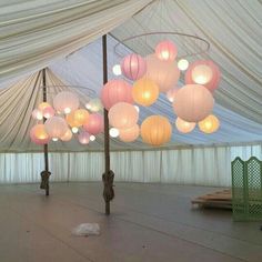 the inside of a tent with many lights hanging from it