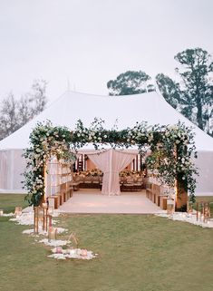 an outdoor wedding setup with flowers and greenery