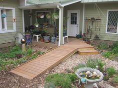 a house with a wooden walkway leading up to the front door and back porch area