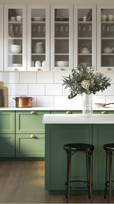 a kitchen with green cabinets and white counter tops