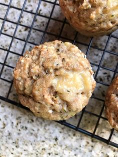 three muffins sitting on top of a cooling rack