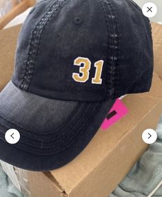 a hat with the number thirteen on it sitting in a cardboard box next to other items