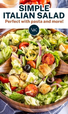 a salad with lettuce, tomatoes and olives is shown in a wooden bowl