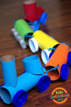 colorful paper tubes are lined up on a table with the words kids activities in front of them