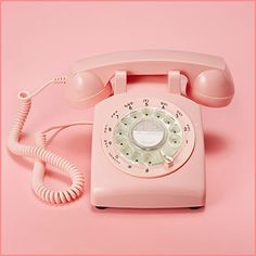 an old pink phone on a pink background