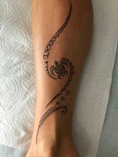 a woman's foot with a tattoo on it and an ornate design in the middle