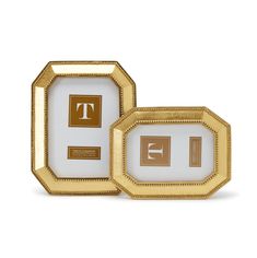 two gold and white plates with the letter t on them