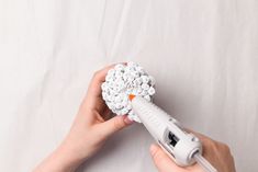 a person holding a hair dryer in their hand