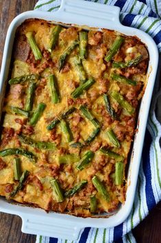 a casserole dish with asparagus and meat