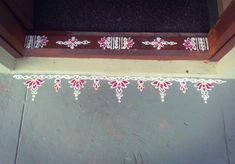 a window sill decorated with red and white flowers on the side of a building