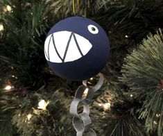 a blue ornament hanging from a christmas tree