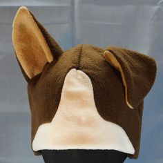 Ultrasoft fleece COCKED-EAR DOG hat with 3D ears--one floppy and one upright--a solid base and ears, a white muzzle blaze, and pale ear lining.  This hat's cozy layers will keep you warm through the coldest days! Perfect for cold weather outdoor fun, a costume, or to make a statement.  Will fit most adults.  Multiple color variations are available so PLEASE specify which color style is preferred. If choosing the Custom Colors option, please write your color choices in the "Personalization" field Dog Ears, Dog Hat, Dog Costume, Ear Hats, Natural Colors, Polar Fleece, Multiple Color, Outdoor Fun, Cold Day