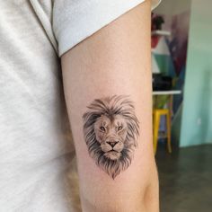 a lion tattoo on the left arm